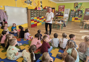 sala przedszkolna, przedszkolaki, mężczyzna z flagą Polski w ręku